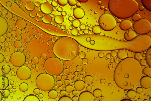 Close up of oil drops on water surface. Colorful abstract macro background of oil drops on water surface with air bubbles inside. Colorful background for gadget and computer wallpaper