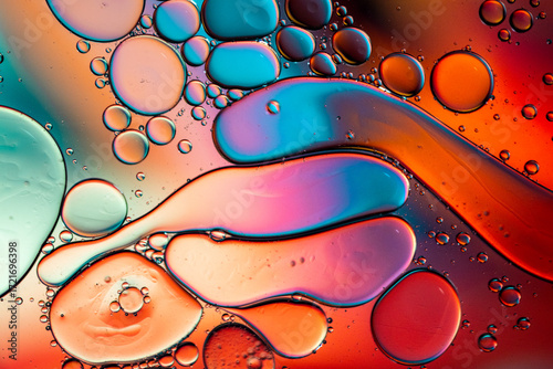 Close up of oil drops on water surface. Colorful abstract macro background of oil drops on water surface with air bubbles inside. Colorful background for gadget and computer wallpaper