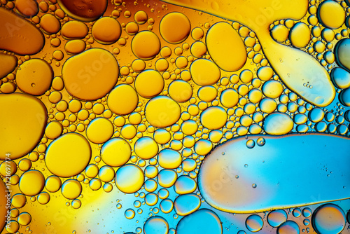 Close up of oil drops on water surface. Colorful abstract macro background of oil drops on water surface with air bubbles inside. Colorful background for gadget and computer wallpaper