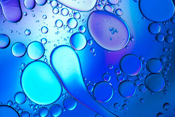 Close up of oil drops on water surface. Colorful abstract macro background of oil drops on water surface with air bubbles inside. Colorful background for gadget and computer wallpaper
