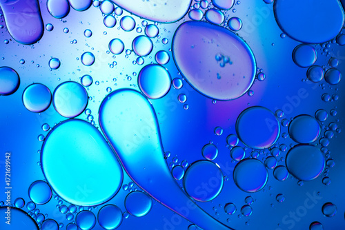Close up of oil drops on water surface. Colorful abstract macro background of oil drops on water surface with air bubbles inside. Colorful background for gadget and computer wallpaper