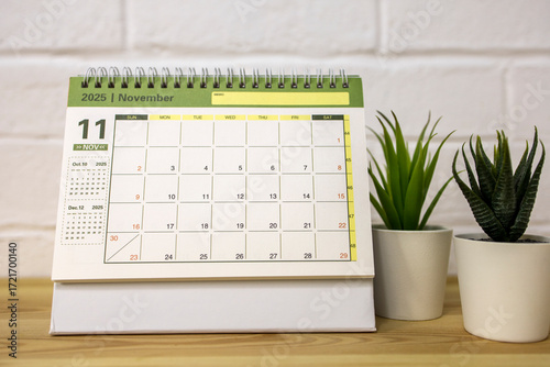 Hello, November 2025. A desktop calendar for planning on the table.