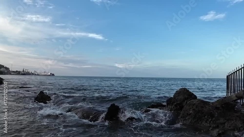Wallpaper Mural Ocean waves crashing on rocky shore with blue sky Torontodigital.ca