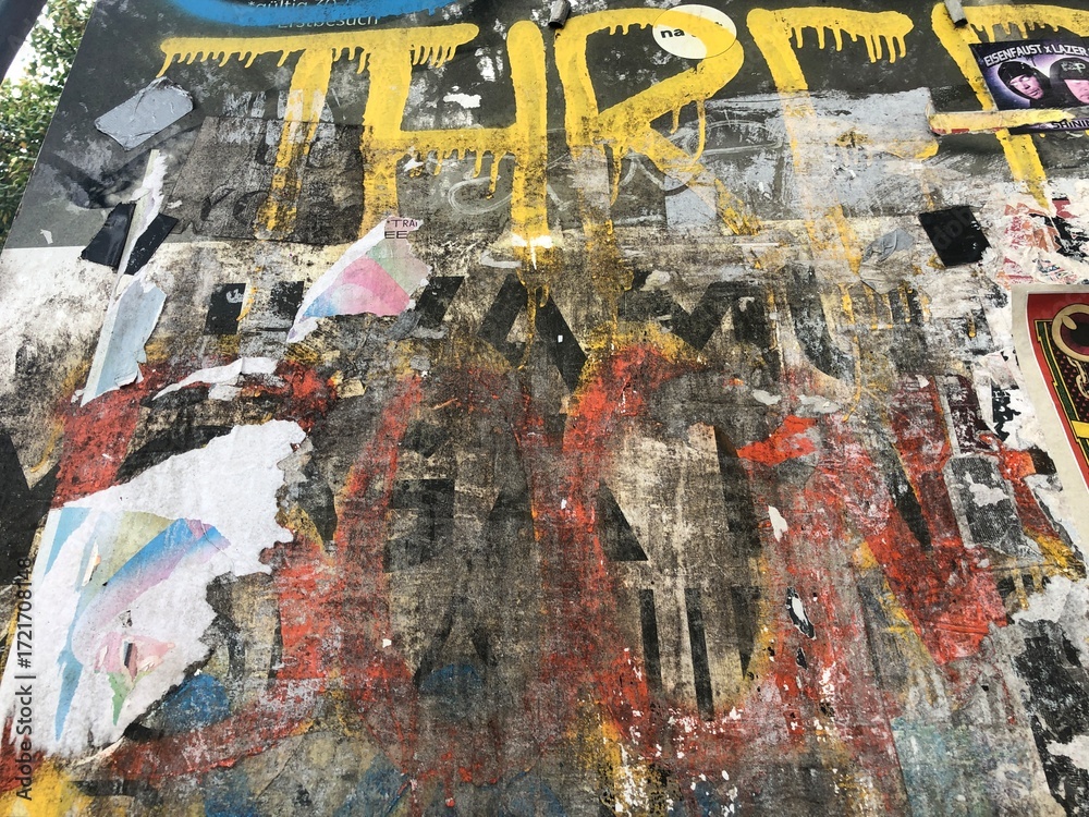 Fototapeta premium Colorful peeling posters distressed paper texture graffiti detail urban decay wallpaper background