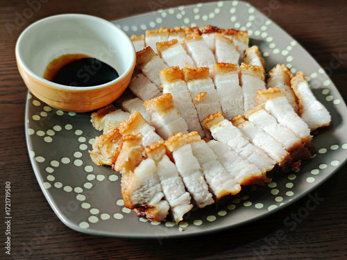 Crispy fried pork belly on a wooden table