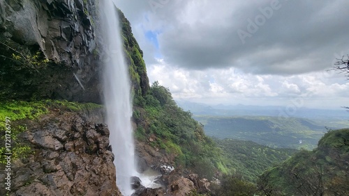 Lakshmi waterfall with clouds in the background near Kelad, Pune