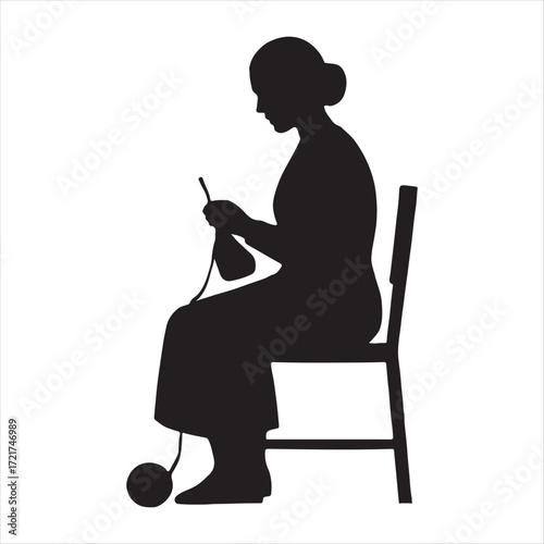 Silhouette of a woman sitting on a chair knitting with yarn and needles creating a craft