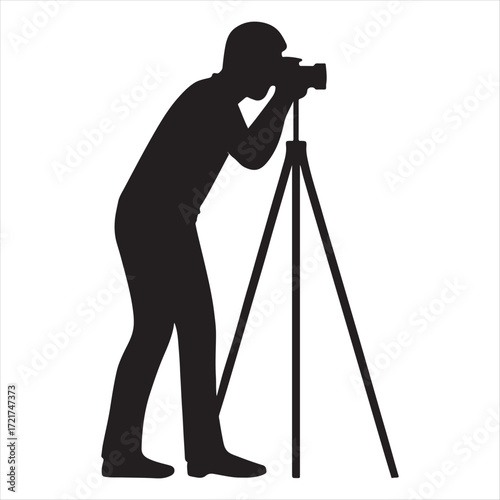 Silhouette of a photographer taking a picture with a professional camera on a tripod