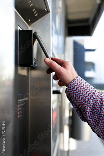 Mobile phone makes a contactless payment at a terminal, demonstrating modern digital technology, mobile banking, and safe cash-free payments. Suitable for fintech, innovation, and cashless living.