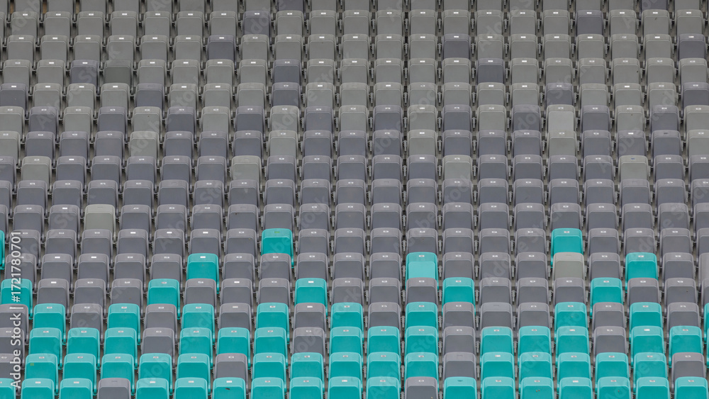 Fototapeta premium The stadium features a distinct pattern of grey and teal seats, showcasing an empty area before the match begins.