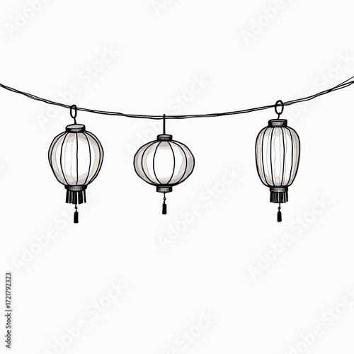 Decorative paper lanterns hanging on string against white background  