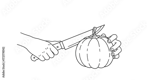 Hands holding knife while carving pumpkin for Halloween decoration  