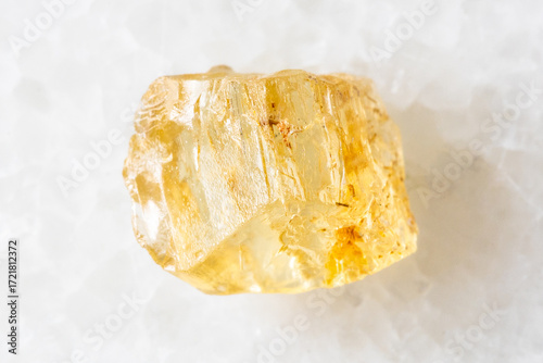 sample of raw yellow scapolite crystal on white