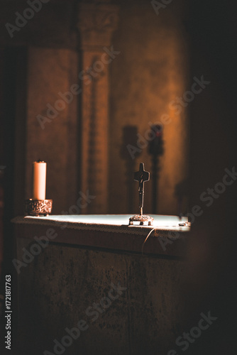 interior of a church with crucifix on the altar seen from outside the entrance door