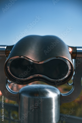 Fixed position of a stainless steel binocular for tourist observation of the city seen from close up