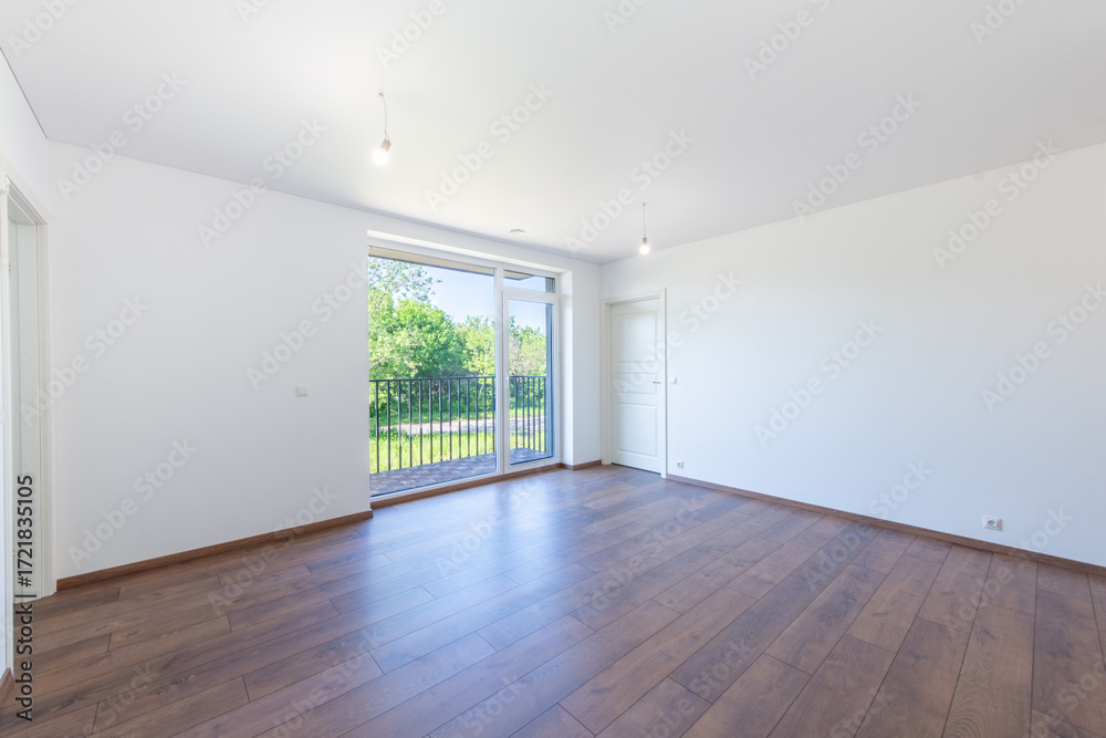 Obraz premium Minimalist Apartment Interior with Wooden Floors and Large Balcony Windows