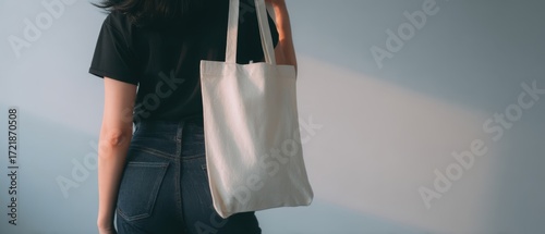 The minimalist woman with a stylish tote bag in soft lighting