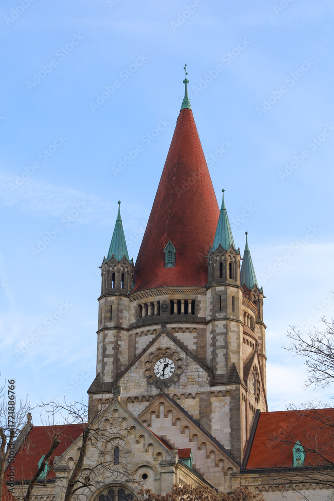 Fototapeta premium An ancient Christian church with a red roof. An ancient church with towers