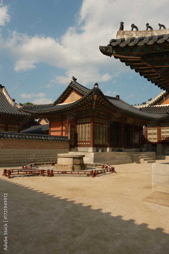 Fototapeta premium A beautifully preserved example of traditional Korean architecture, featuring intricate roof designs and historical structures. Captured on a sunny day in May 2025, this image showcases the cultura...