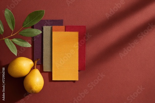 Warm color palette featuring vibrant paper sheets and fresh pear