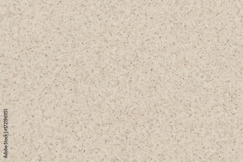 A close-up of a beige speckled stone surface. A neutral and modern texture for countertops, floors, and architectural design backgrounds.