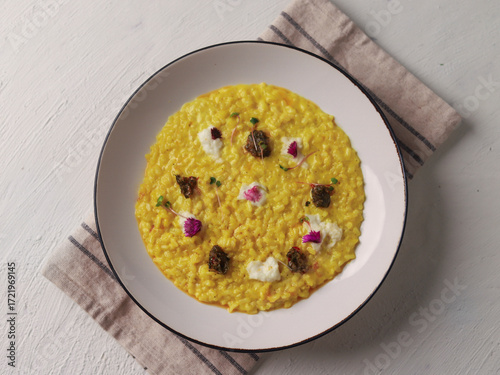 Yellow Risotto Served in White Bowl with Spoon