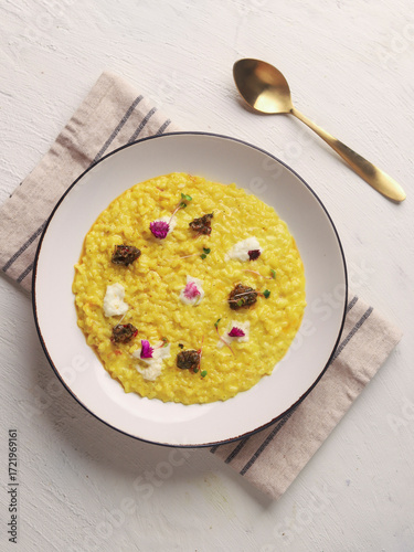 Yellow Risotto Served in White Bowl with Spoon