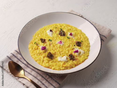Yellow Risotto Served in White Bowl with Spoon