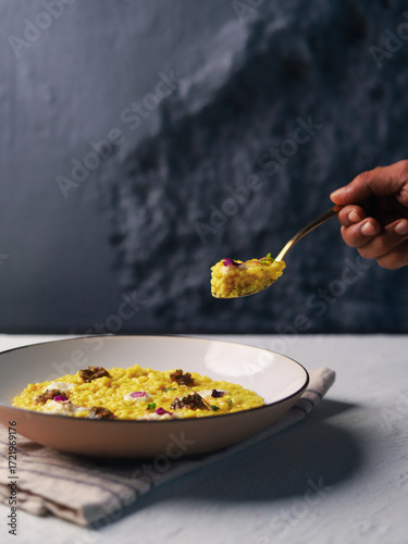 Yellow Risotto Served in White Bowl with Spoon
