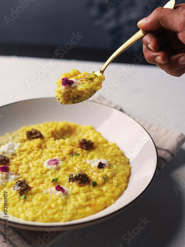 Yellow Risotto Served in White Bowl with Spoon