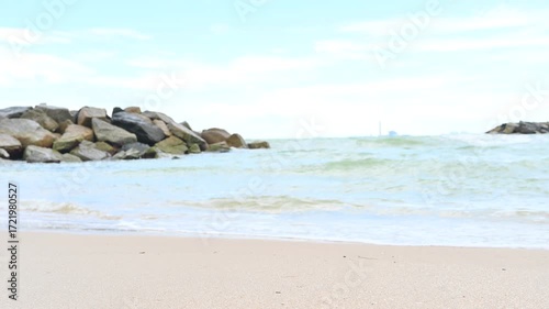 Seashore Serenity: A serene seascape unfolds, with calm, clear waters gently caressing the sandy shore and a view of the horizon on a beautiful day.