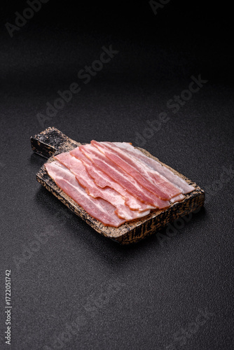 Raw or smoked pork bacon slices or strips as a breakfast ingredient. Raw bacon