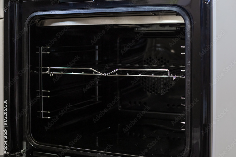 Obraz premium An open oven with metal grates, ready for cooking