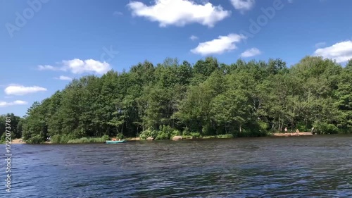 Summer river landscape with a rowboat, time lapse