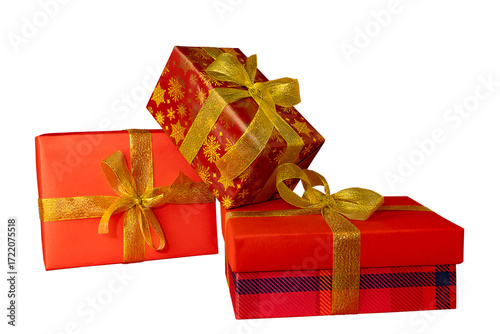 A close-up view of three beautifully wrapped red gift boxes adorned with gold ribbons and bows.
