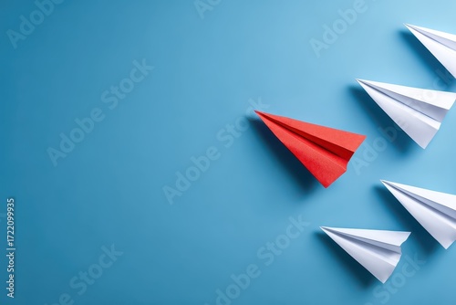 Creative approach to business innovation illustrated by a group of paper airplanes in distinct colors flying in different directions against a blue background