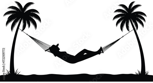 A peaceful silhouette relaxes in a hammock between two palm trees