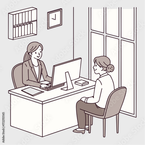Two Businesswomen in Office Meeting at Desk.
