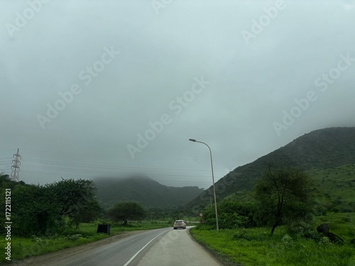 Beautiful road in Salalah, Oman, captured in natural daylight. The image/footage showcases smooth and well-maintained roads surrounded by greenery, mountains, or open landscapes unique to southern Oma