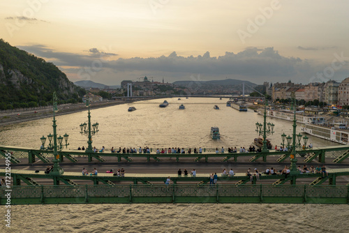 People sitting on the Liberty bridge in Budapest city, Hungary, Europe.