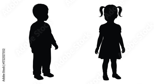 Silhouette of a young boy and girl standing side by side