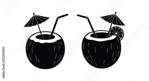 Two black and white coconut drinks with umbrellas and citrus slices