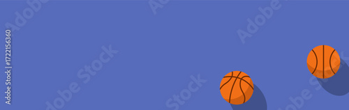 Two orange basketballs placed on a simple blue backdrop.