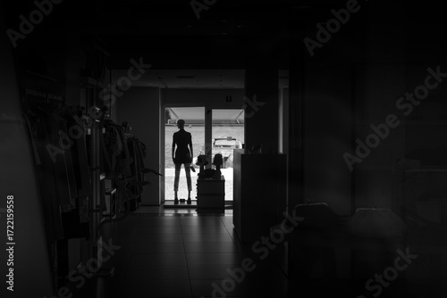 Black and White Clothing Store Interior with Silhouetted Mannequin