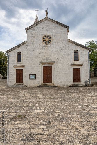 Historic Stone Church With Tower And Cross Against Blue Sky, Rustic Village Architecture, Gornje Selo, Solta Island
