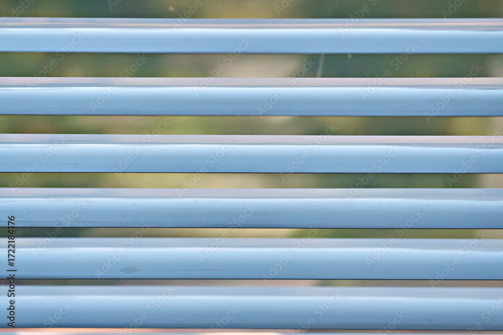 Fototapeta premium The windows of the house are decorated with white blinds. Close-up, selective focus