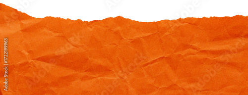 Ripped edge of bright orange crumpled paper, isolated textured scrap for collage in autumn colors