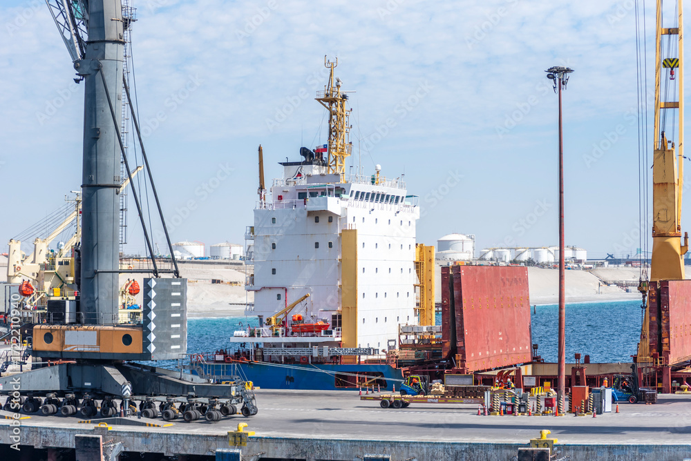 Fototapeta premium Bulk carrier ship docked at a port terminal with its cargo hold open. Puerto Angamos, Chile.