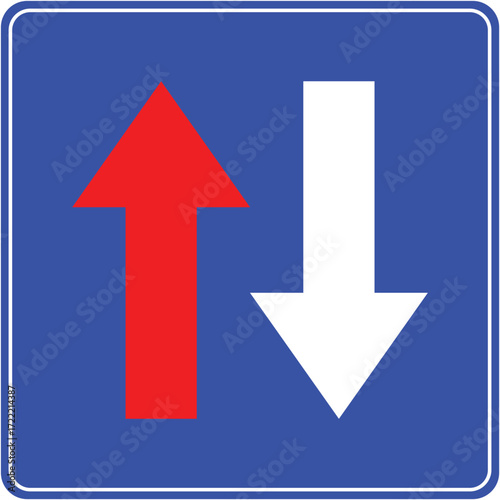 Priority road sign with red and blue arrows showing vehicle right of way.
