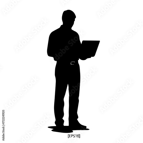 Businessman using laptop while standing in silhouette format  